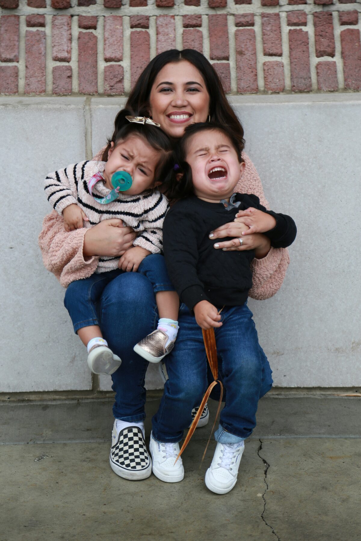 A mother walking with her two children through downtown