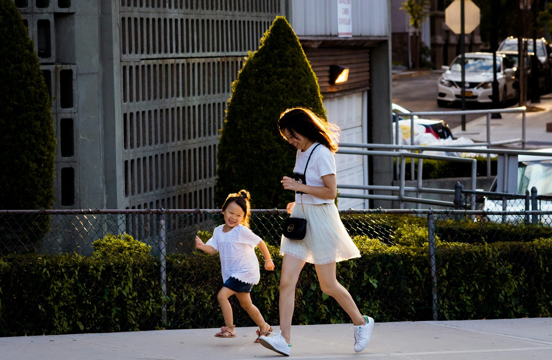 A mom and toddler running through a Cary courtyard