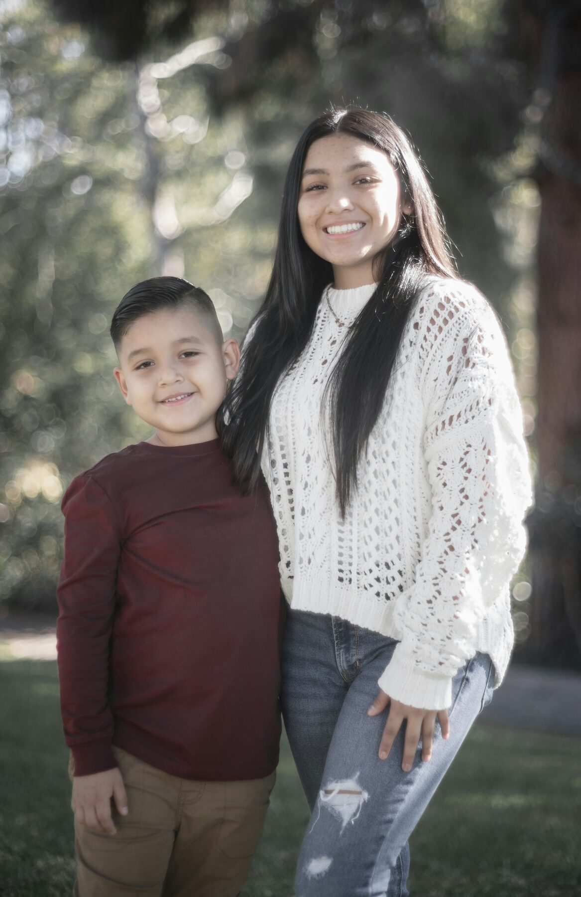 A young boy with his mom standing among tall grass